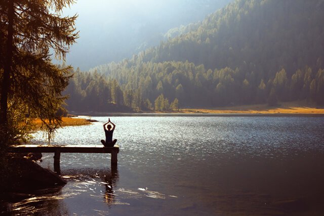 Meditation on a lake on a sunny day