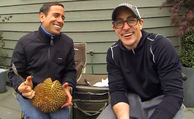 Victor VanRambutan and Michael Arnstein laugh outside with a durian