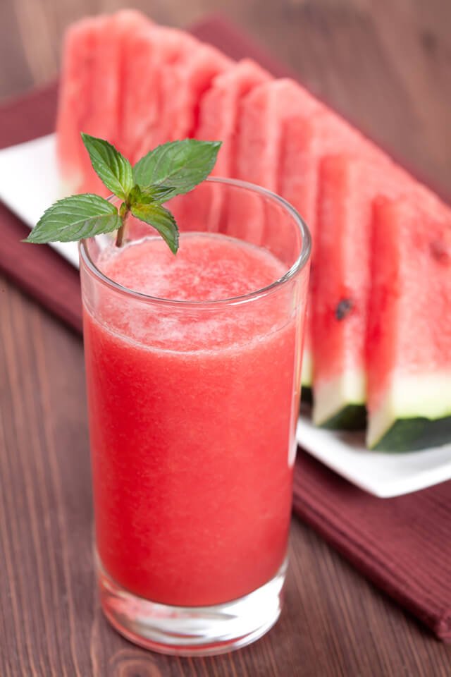 Watermelon smoothie next to watermelon slices