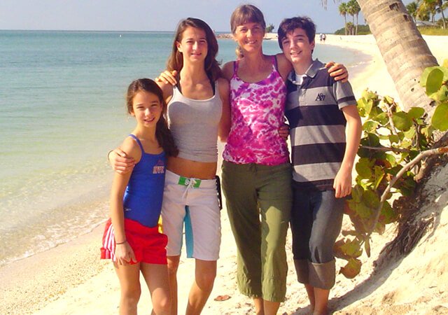 Ellen Livingston poses with her children on a beach