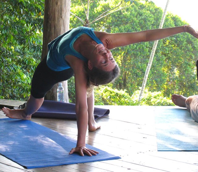 Ellen Livingston practices yoga in a structure outdoors