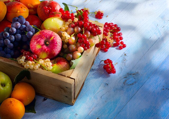 Colorful fruits in a box on a deck