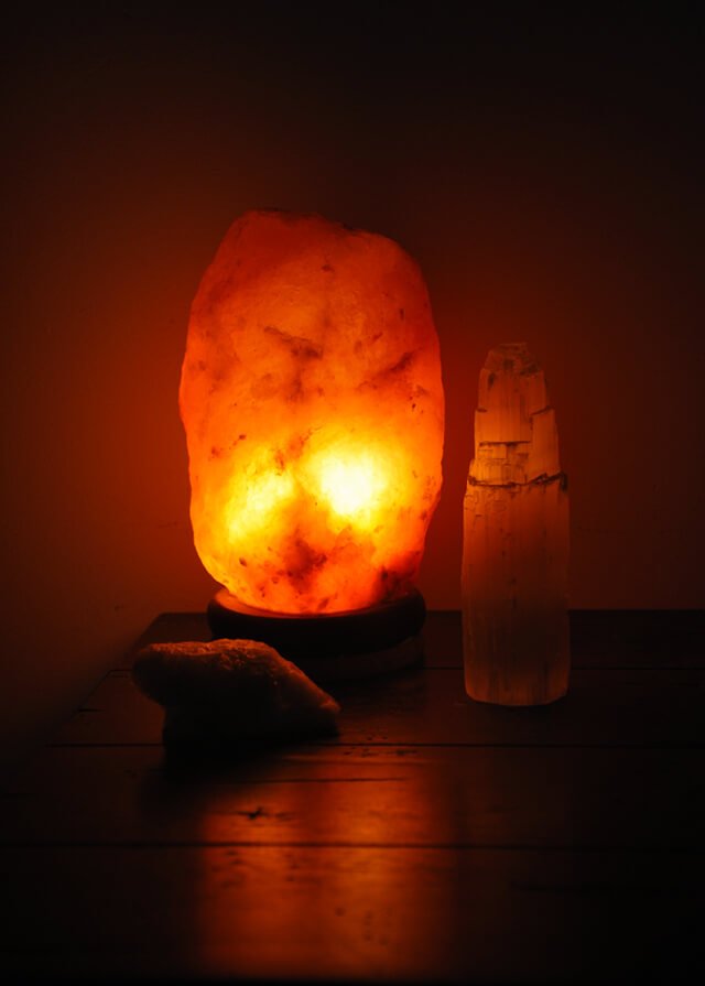 A Himalayan salt lamp lights up part of a room
