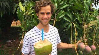 Robby Barbaro holds a coconut outside