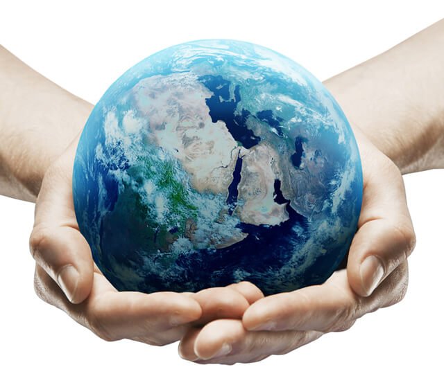 Hands holding earth against a white background