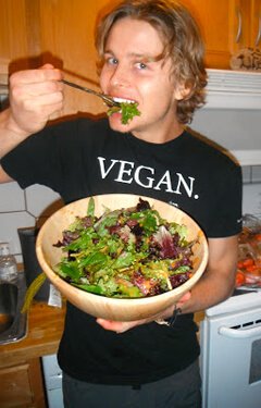 Evan Rock eats a salad in a kitchen
