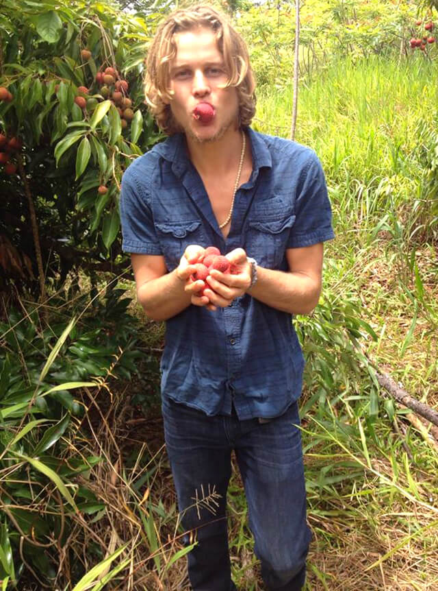 Evan Rock eats fruit outside