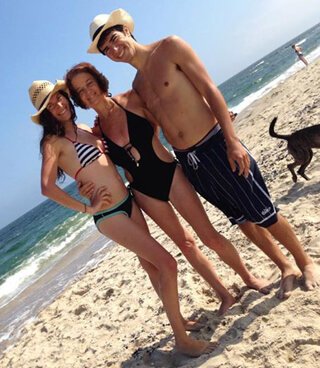 Karen Ranzi with children Marco and Gabriela on a beach celebrating Karen's 60th birthday