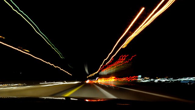 Light pollution at night viewed from a car in slow-capture photographic mode