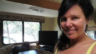 Joy King in her RV with Harley by a window