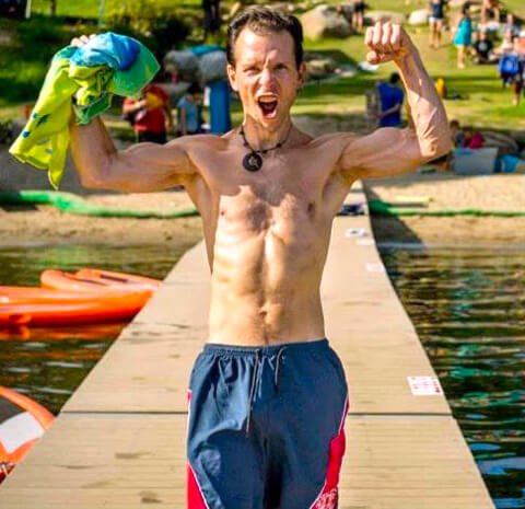 Dr. Samuel Mielcarski flexes his biceps at The Woodstock Fruit Festival