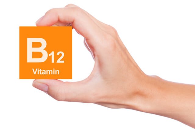 Hand holds Vitamin B12 block