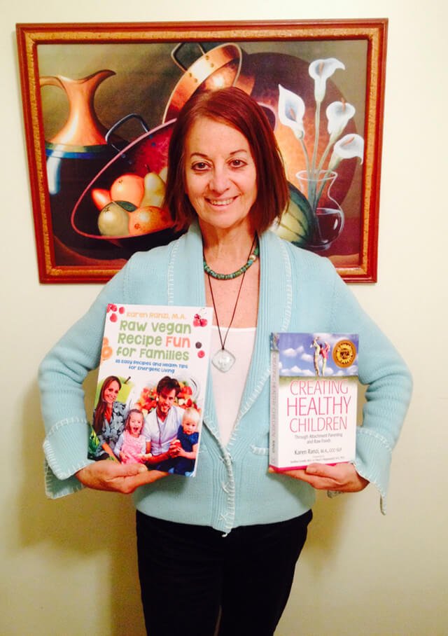 Karen Ranzi holds up her books