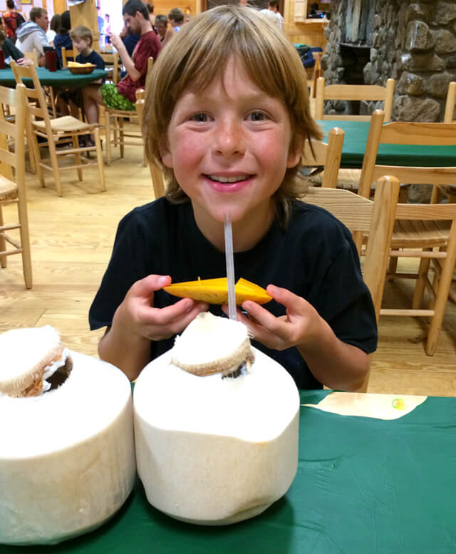 Raw Food Levi eats coconuts and mangos at The Woodstock Fruit Festival after competing in a triathlon