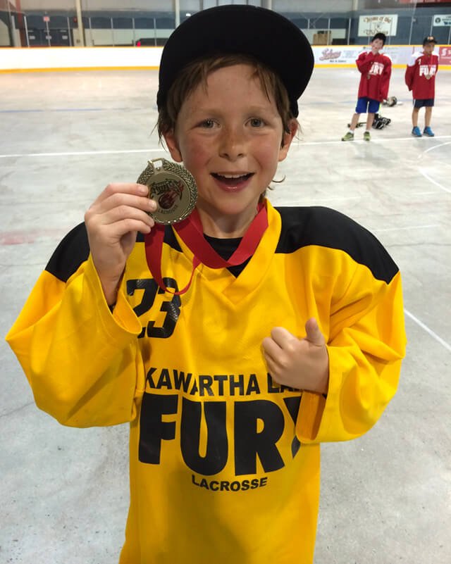 Raw Food Levi holds his medal for a lacrosse championship