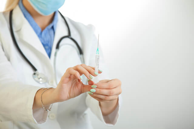 A doctor prepares to administer an injection