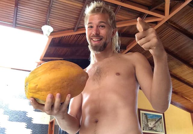 Jason Kvestad holds a piece of fruit