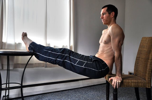 Korey Constable performs dips using a chair