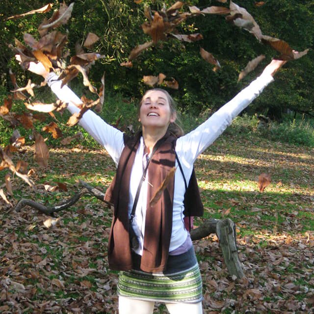 Reny Kattel joyously plays with fallen tree leaves