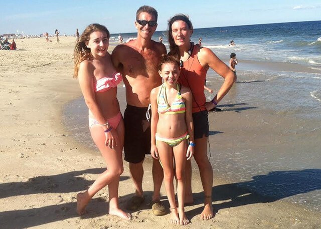 Cassandra Glynn Kutner poses with her family on a beach