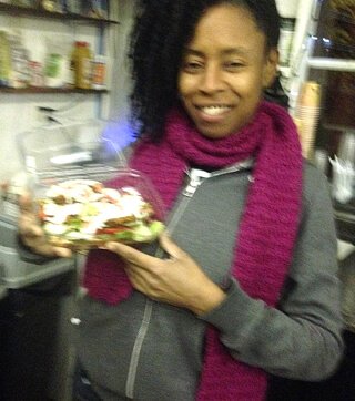 Sandra Woods holds a Cheezeberger Sandwich at Arnold's Way