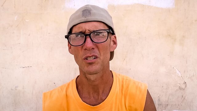Mark Tassi is photographed on a street corner in Cambodia