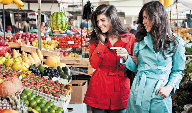 Women shop in a produce section