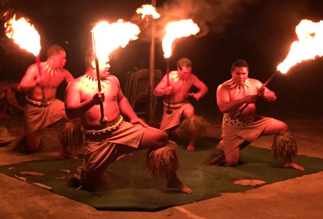 Fire dancers perform at night at The Woodstock Fruit Festival Hawaii.