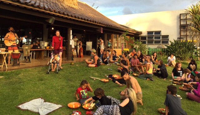 Gatherers listen to Paul Itzak perform at The Woodstock Fruit Festival Hawaii