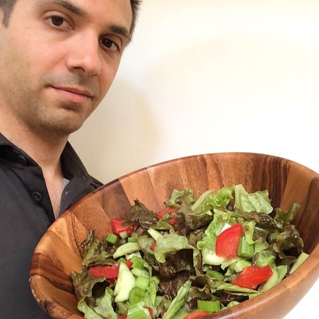 John Fallucca holding a bowl filled with salad