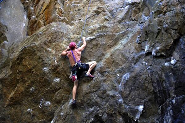 Korey Constable rock-climbs