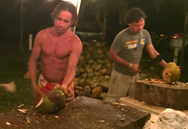 Michael Arnstein and John Kohler chop coconuts at The Woodstock Fruit Festival Hawaii