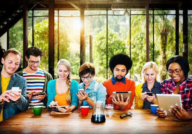 Seven people absorbed with technology and not speaking to one another