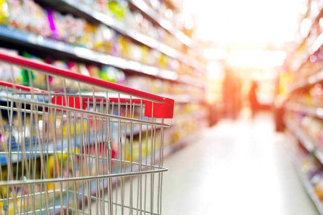 A shopping cart is being navigated in a grocery store
