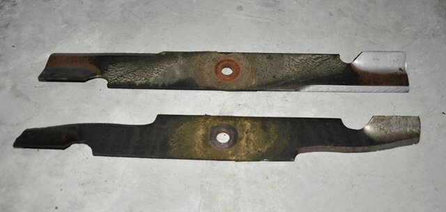 Photographed are highly and lightly worn lawnmower blades