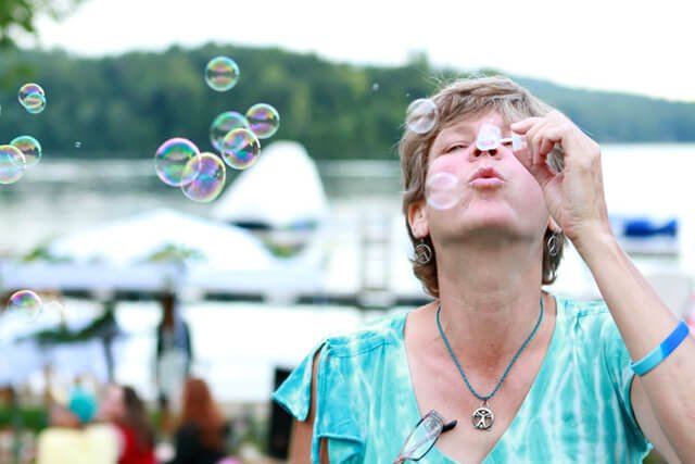 Itsy Sweeney blows bubbles at the 2014 Woodstock Fruit Festival