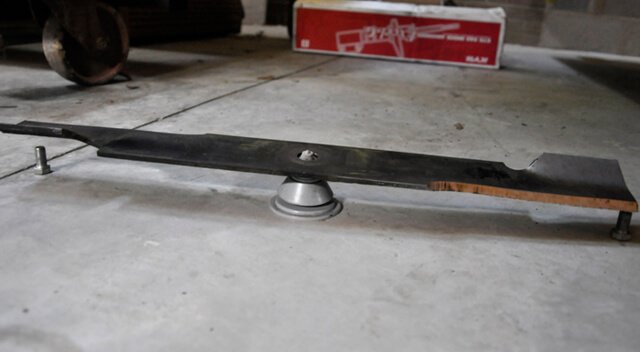 Lawnmower blade balances on a cone