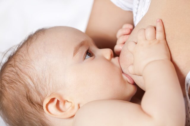A baby breastfeeds