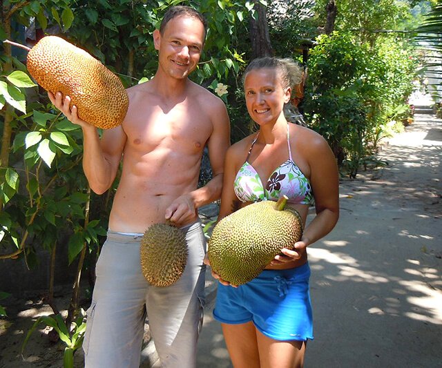 Petr and Alexandra Cech hold fruits in Koh Lanta, Thailand
