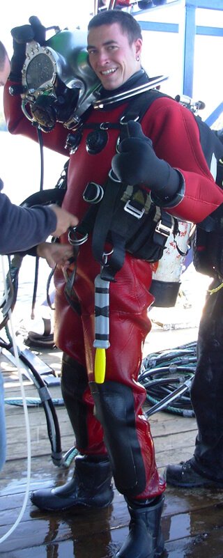 Jon Kozak smiles while suited up in diver gear