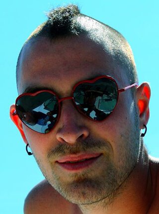 Jon Kozak wears heart-shaped sunglasses
