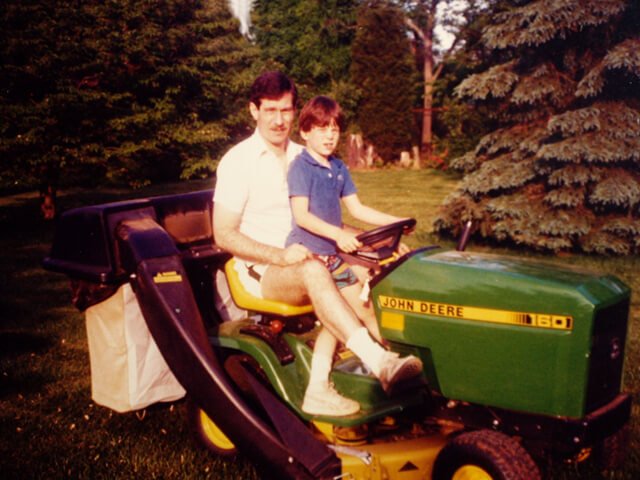 Korey Constable with his father a garden tractor