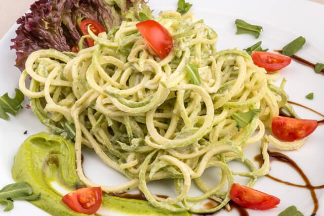 Spaghetti made from zucchini with tomatoes and basil sauce