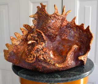 Reddish-orange sea sculpture by Betty Korba