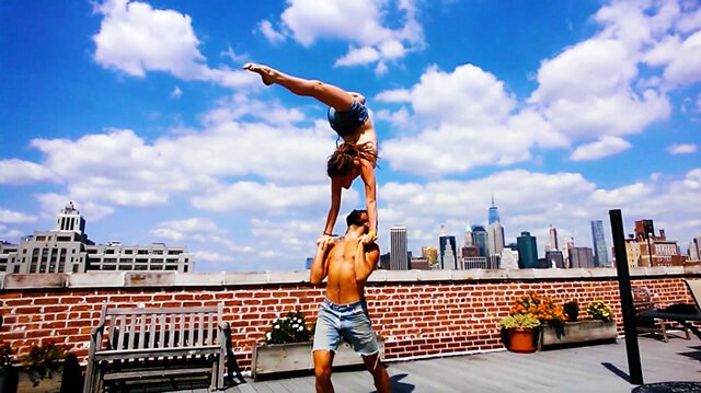 Brittany Taylor practices hand-to-hand acro on a New York City rooftop