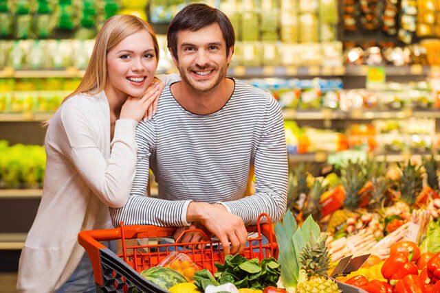 A man and woman shop for fruits and vegetables