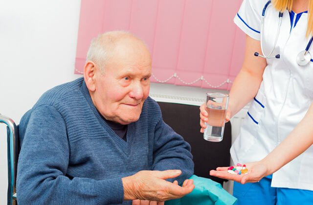 Nurse gives medication to a patient
