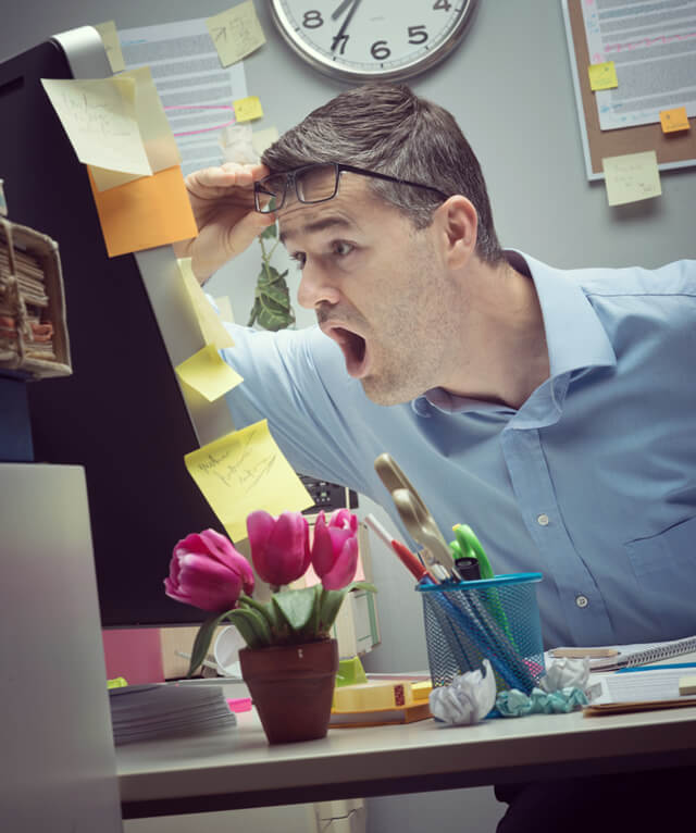 Man reads with mouth agape from a computer screen