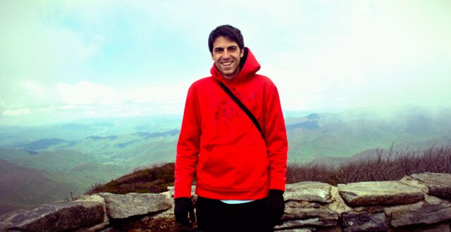 Nathan Oxenfeld smiles while atop a mountain