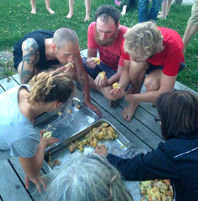 Ronnie Smith joins others in eating fruit at the 2013 Fresh Food Festival